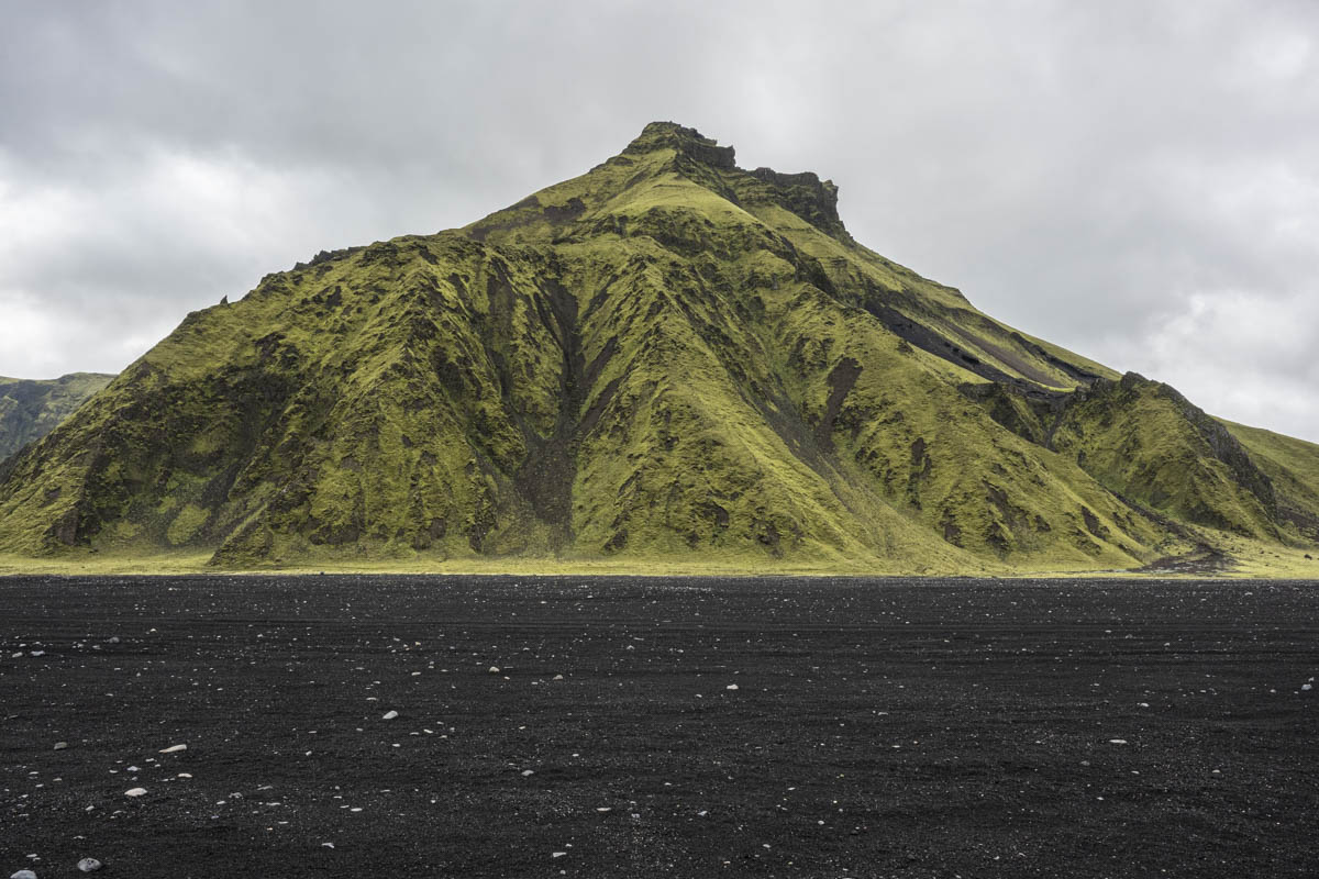 black sand and green mountain